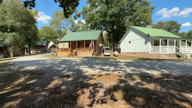 Cabins under the oaks, seen from the lane