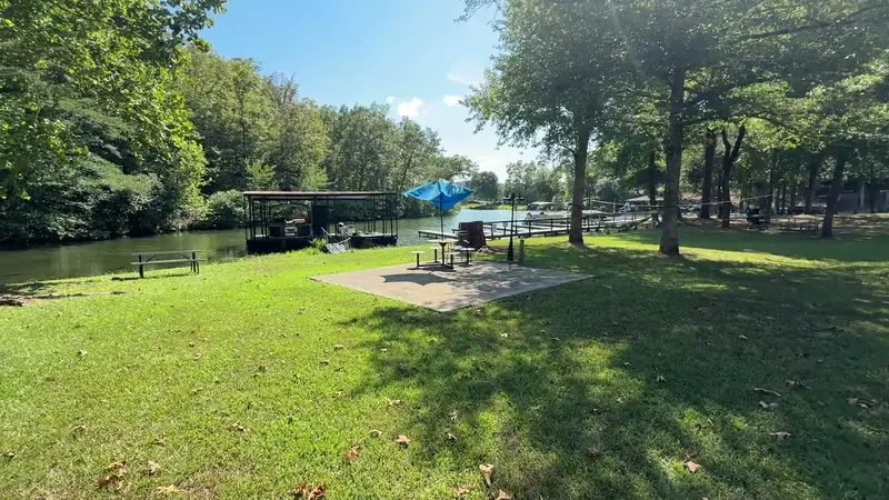 The lawn running down to the water